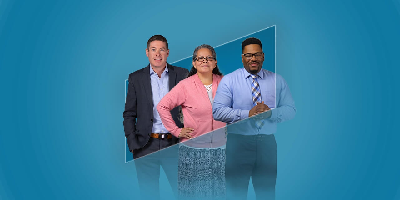 Three Liberty Associates standing in the outline of the Liberty logo