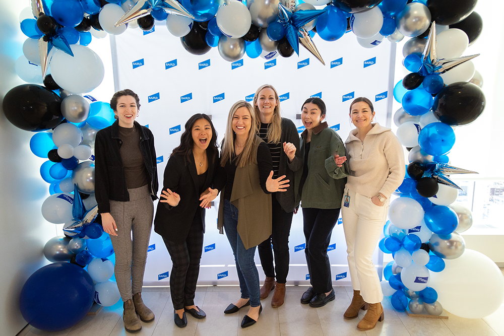 Group of Liberty Associates standing as a group under a balloon arch.