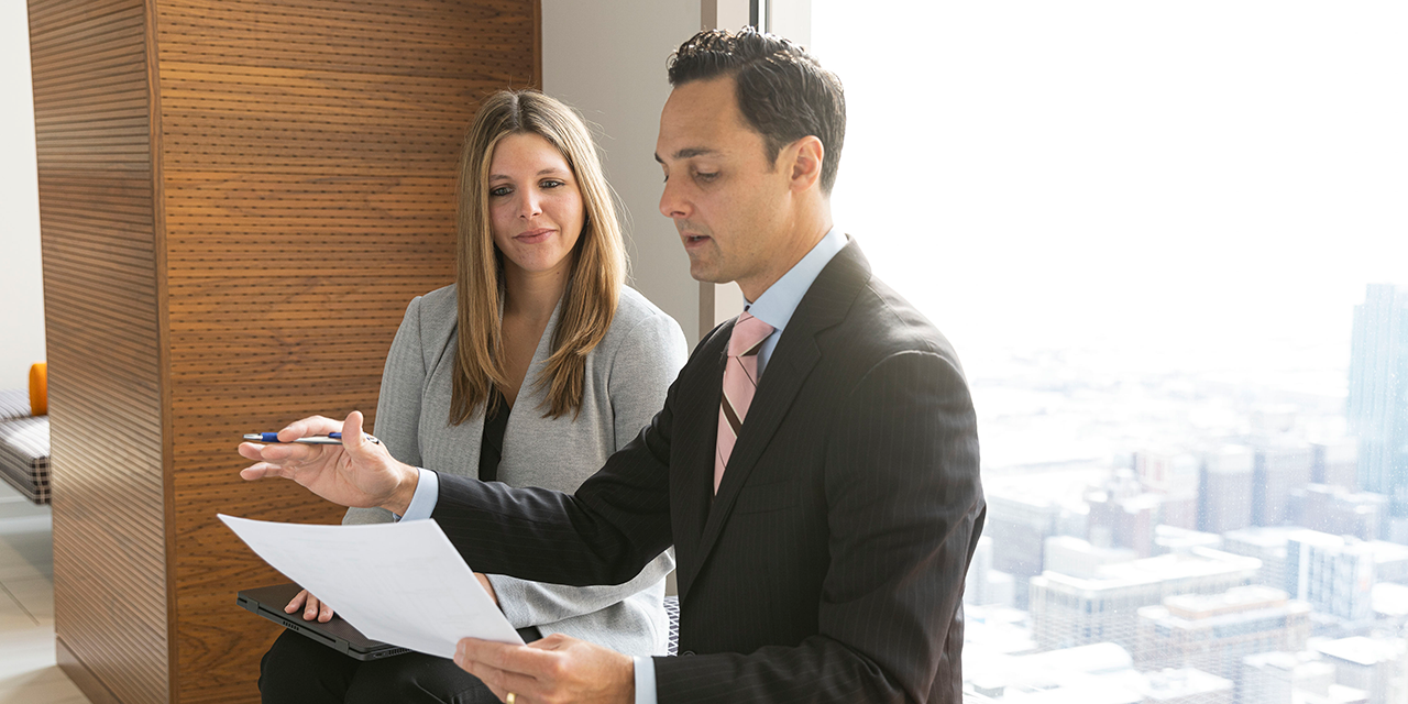  Liberty Fixed Income Capital Markets associates talking in front of a window in Chicago